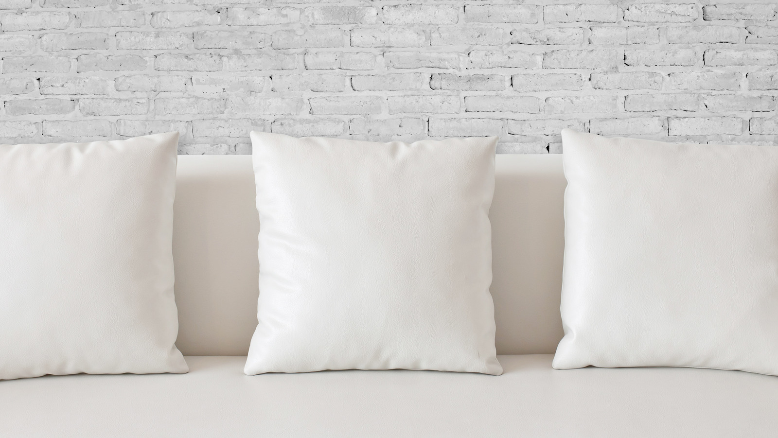 https://www.housedigest.com/img/gallery/why-you-should-reconsider-styling-your-living-room-with-white-pillows/l-intro-1685916429.jpg
