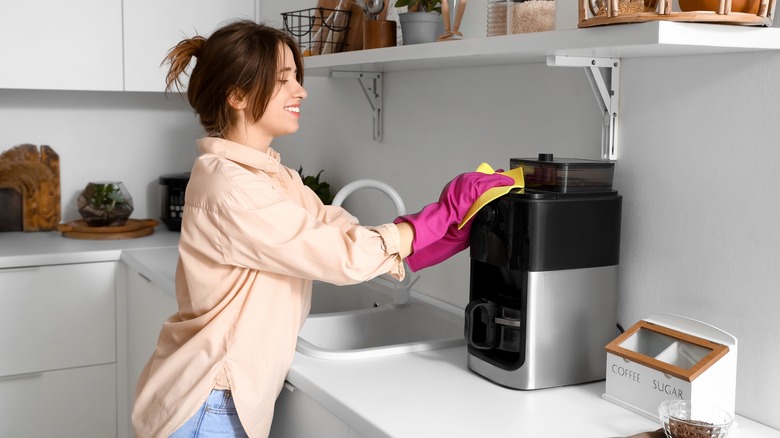 woman cleaning coffee maker