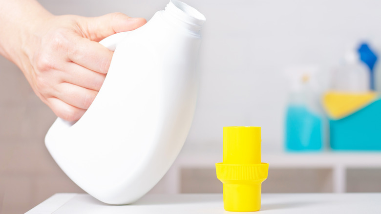 pouring detergent from a bottle