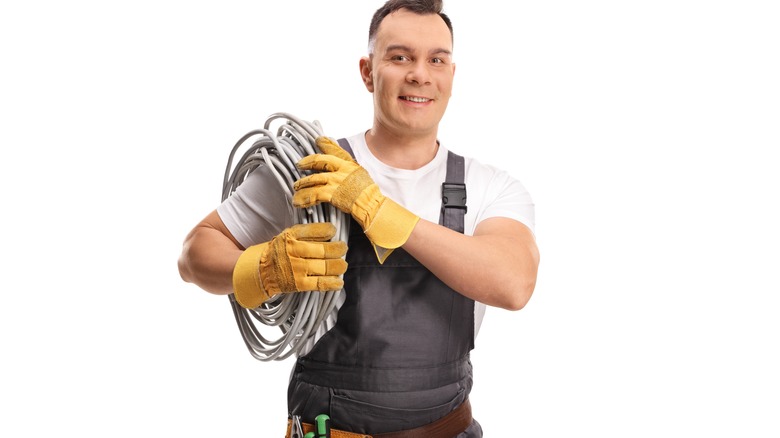 electrician carrying cables