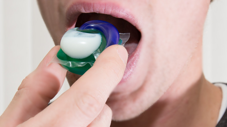 Woman putting laundry pod in mouth