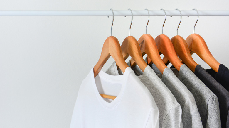 shirts hanging on wooden hangers