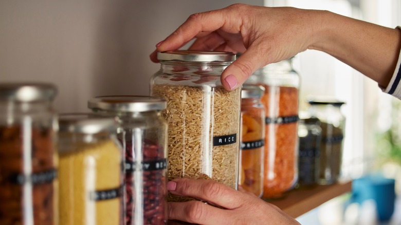 Person holding jar of rice