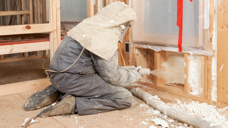 Person spraying foam insulation