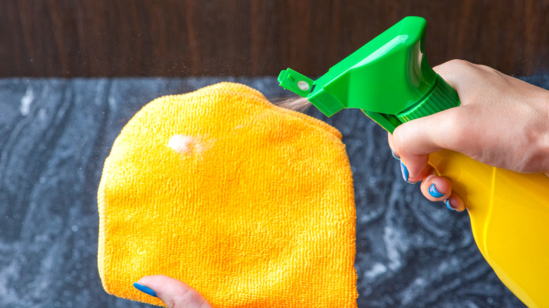 spraying a microfiber towel