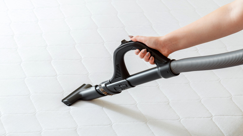 Woman vacuuming mattress