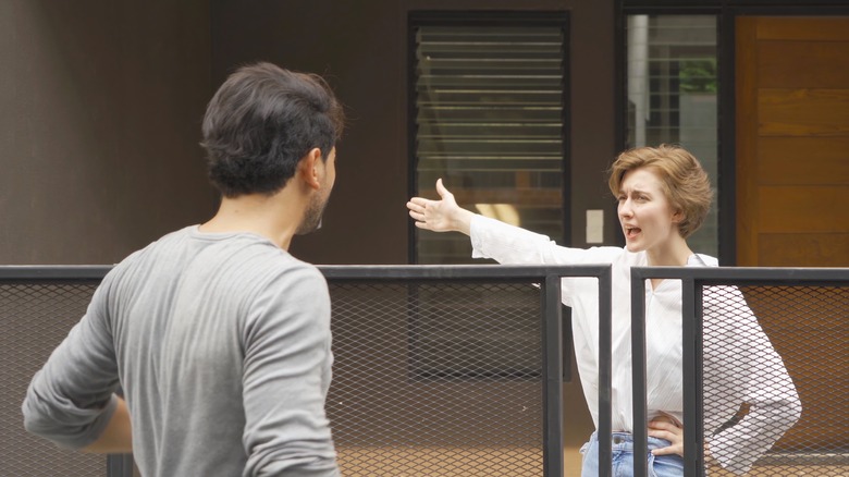 Woman gesturing aggressively at neighbor