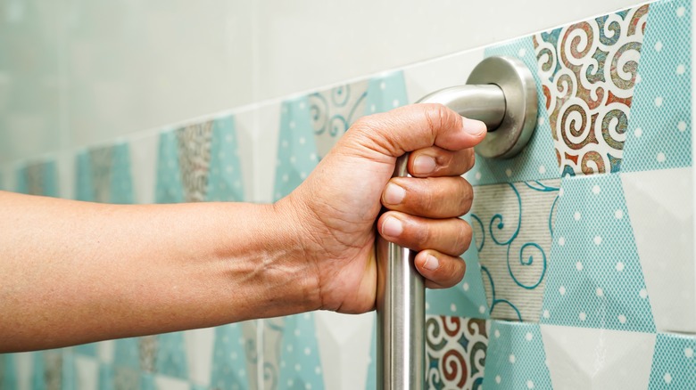 shower grab bar on blue patterned tile