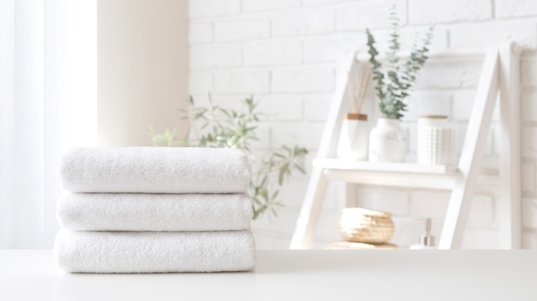 Stack of white towels in bathroom