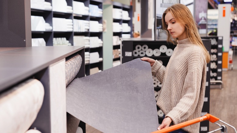 woman buying wallpaper