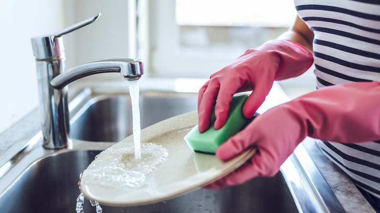 Woman buffing dishes clean