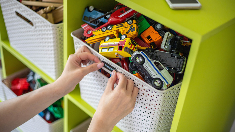 Woman putting label on organized playroom