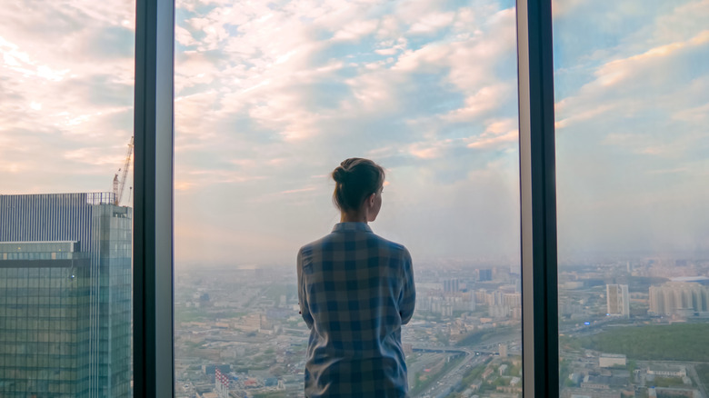 Person looking out large window