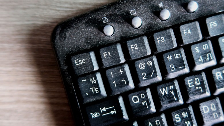 Dirty keyboard covered in dust