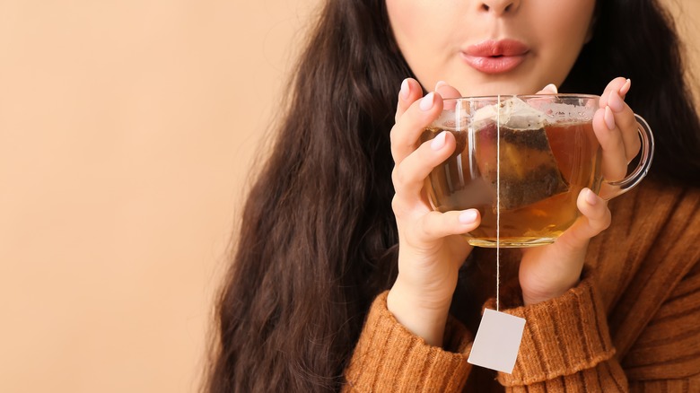 A woman holding cup of tea