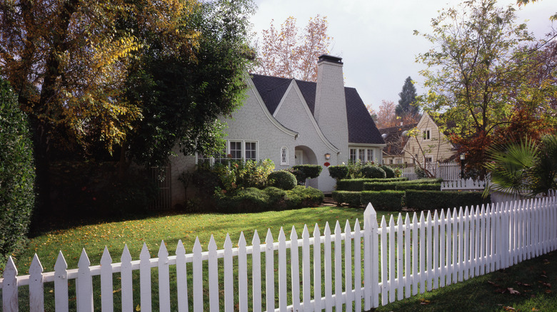 Large yard with small white fence