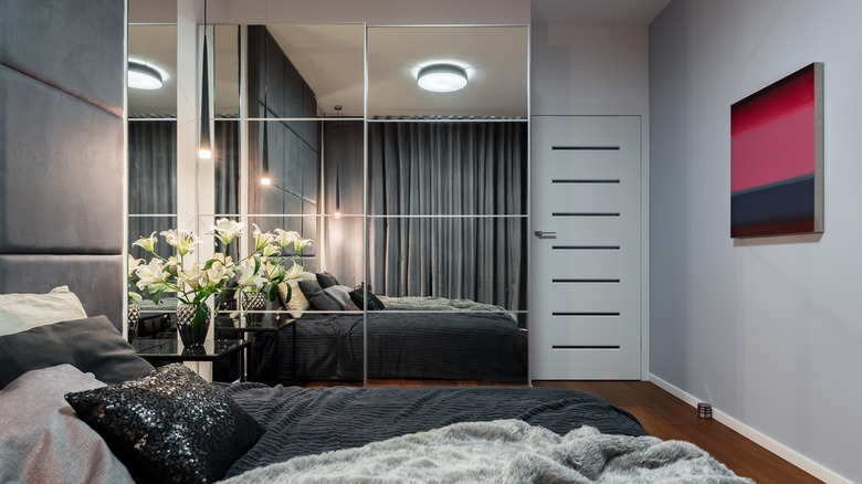 bedroom with mirrors on wardrobe