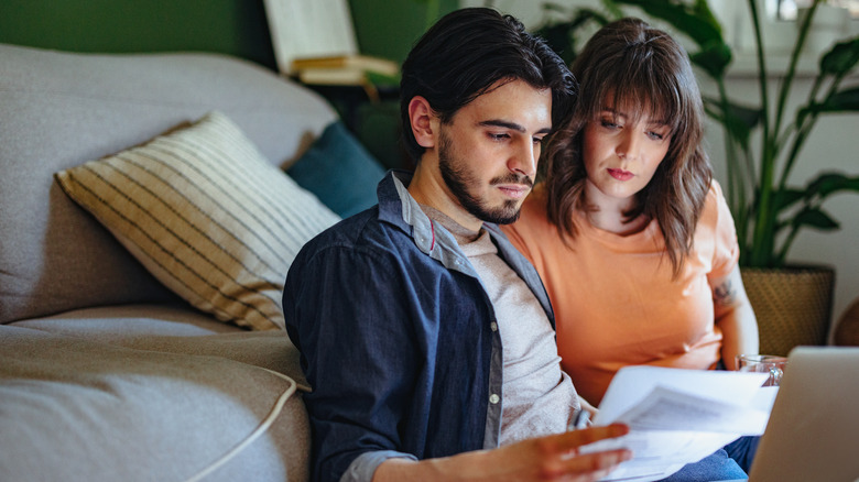 young couple examining electric bill