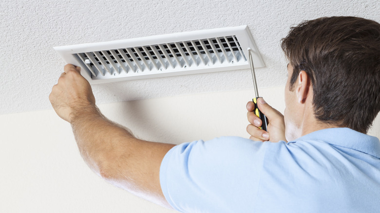 Person removing air vent cover 