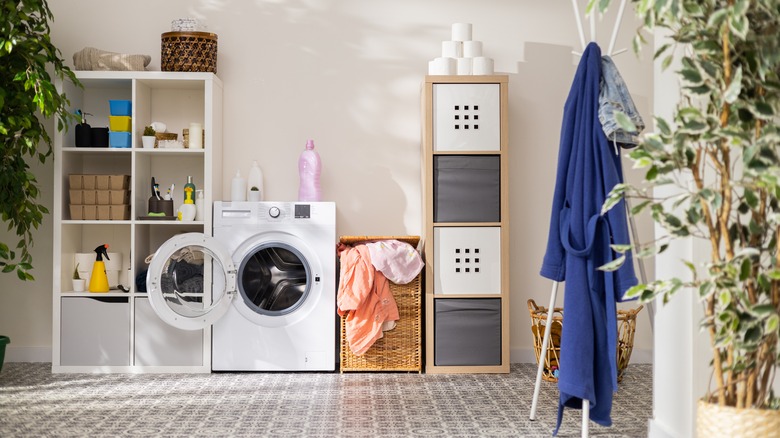 laundry room with storage units