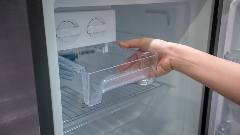 Hand replacing refrigerator compartment