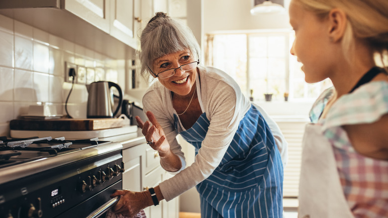 grandma teaching girl to bake