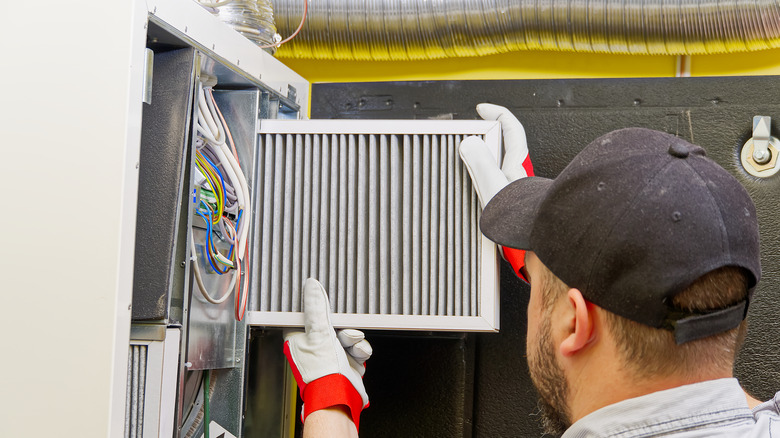 man changing hvac filter