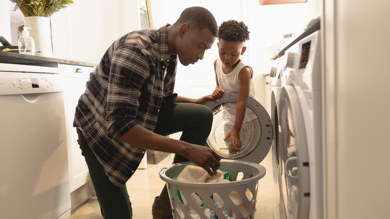 Woman removing clothes from dryer