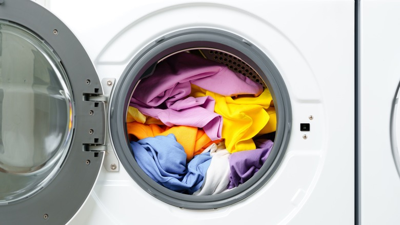 Washing machine crammed with clothing