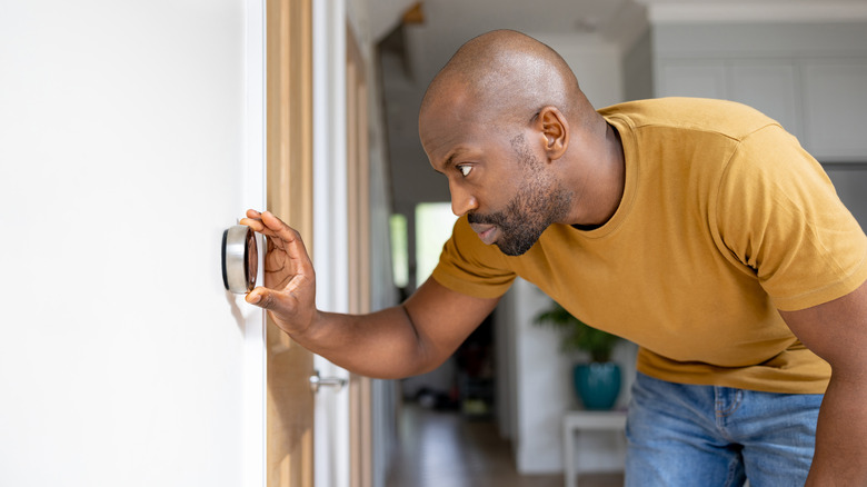 man adjusing air conditioner