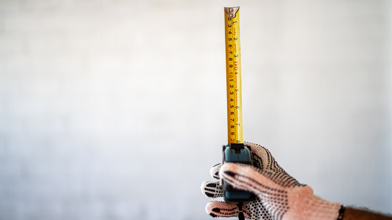 person holding tape measure