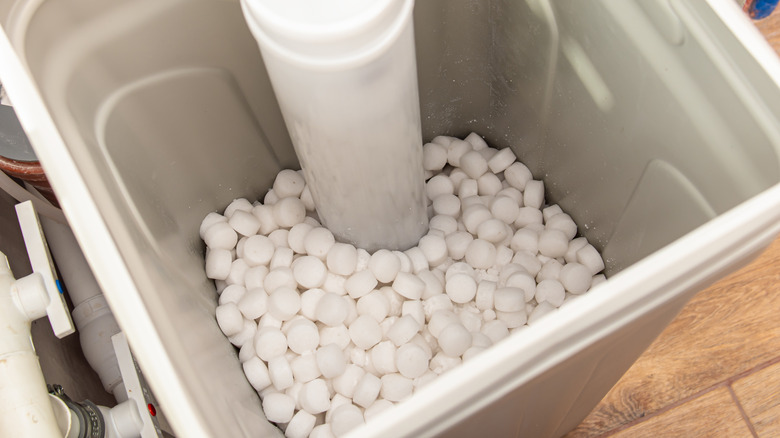 Numerous tablets of salt water softener in an automatic dispenser