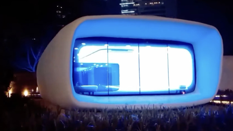 Futuristic 3D-printed office building at night