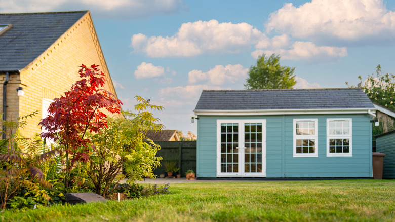 Blue shed next to house