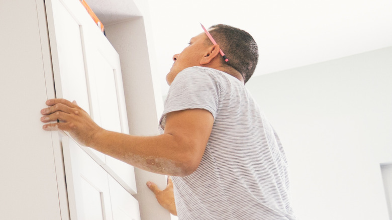 Man installing cabinet