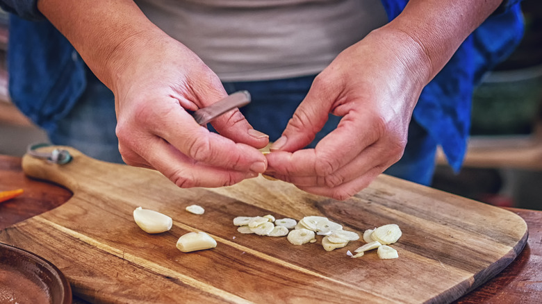 person cutting garlic