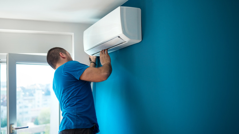 Man looking at air conditioner