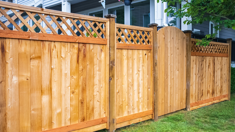 wooden fence with trellis top and gate