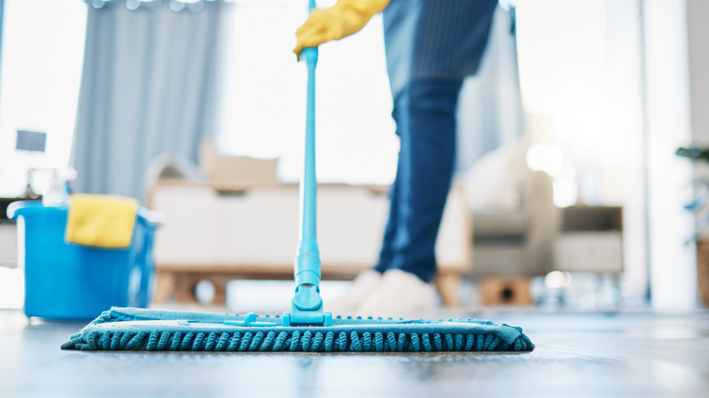 A person cleaning hardwood floors