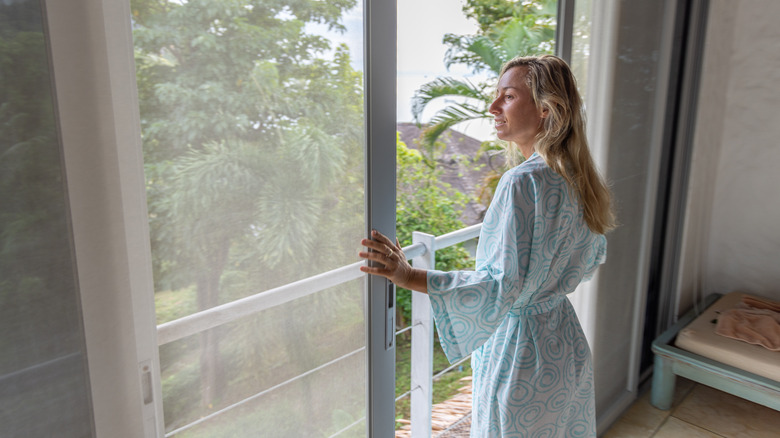 woman standing by sliding door