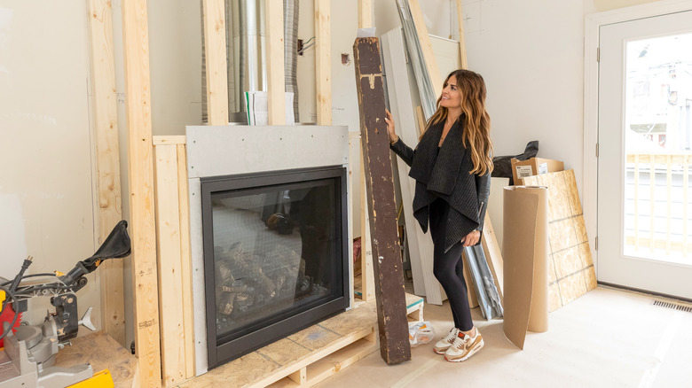 Alison Victoria working on unfinished fireplace