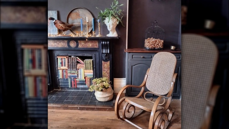 Books stacked in rustic fireplace