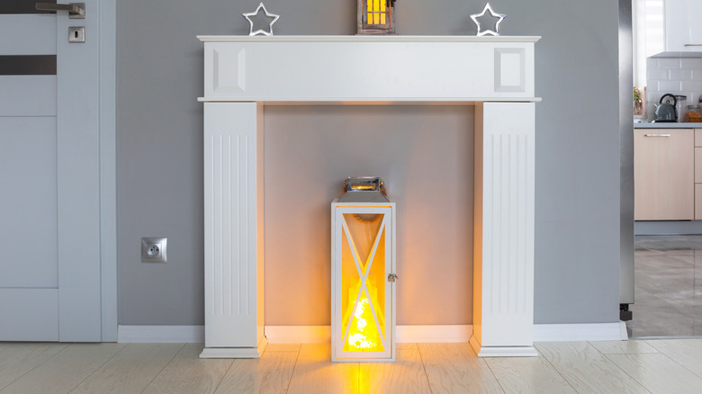 White lantern inside fireplace