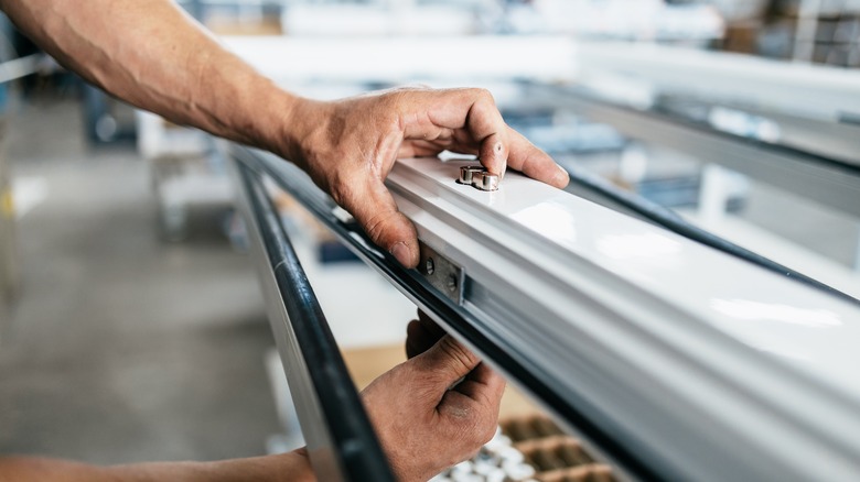 man working on vinyl windows