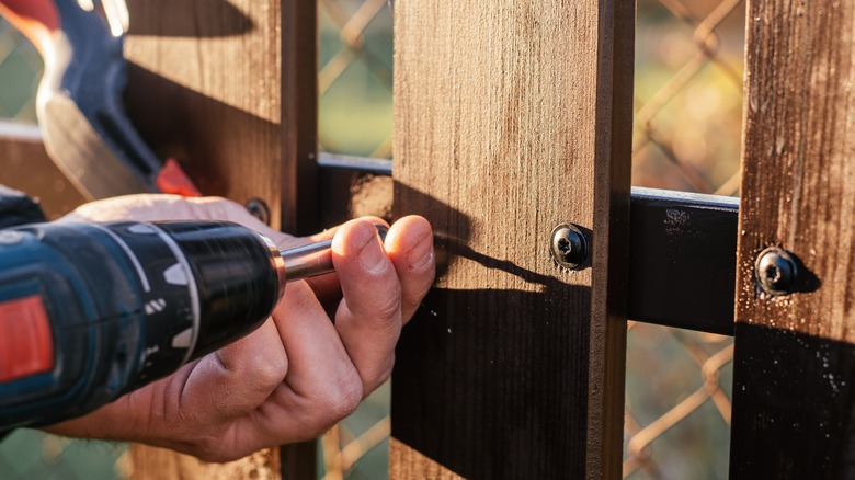 adding screw into a fence