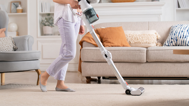 Woman vacuuming area rug