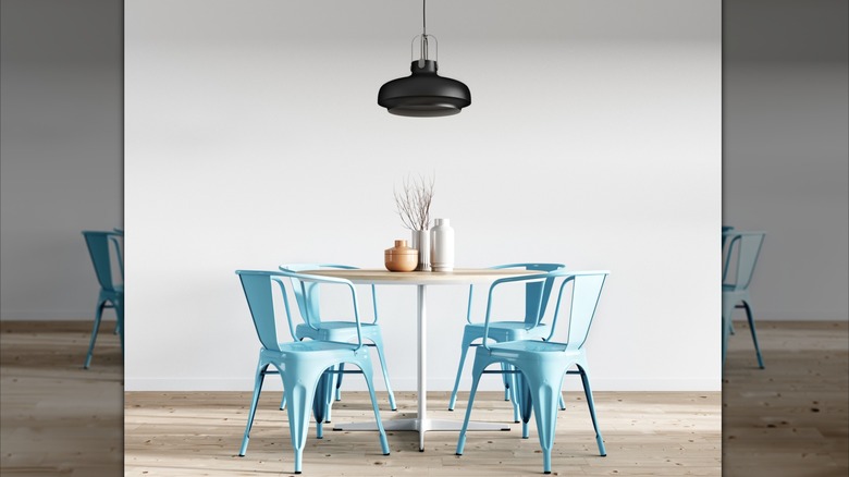 A black pendant in a bright and colorful dining space