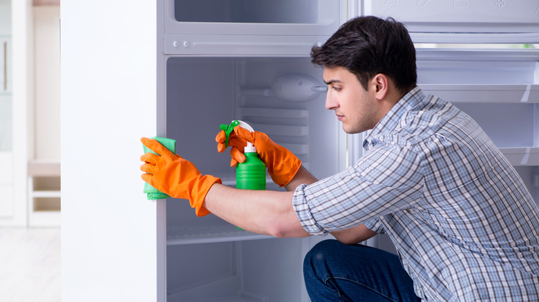 Man cleaning refrigerator