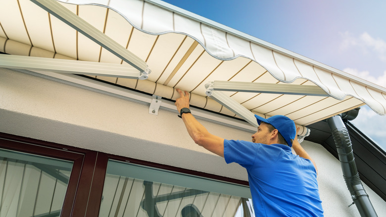 Man installing an awning