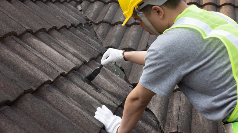 Man installing roof coating